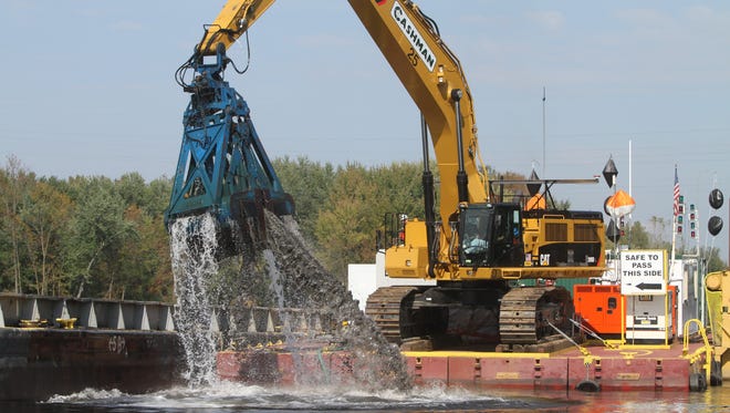 A clamshell dredge lifts sediment from the Hudson River in Fort Edward, N.Y. in September 2011. General Electric, which has conducted the work, announced this month the completion of the multi-year dredging project,