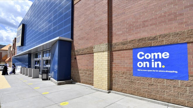 Shoppers, left, head to the entrance as a sign on the outside wall invites customers to shop inside a Best Buy store Wednesday, June 24, 2020 in Richfield, Minn. as restrictions due to the coronavirus have eased in Minnesota.