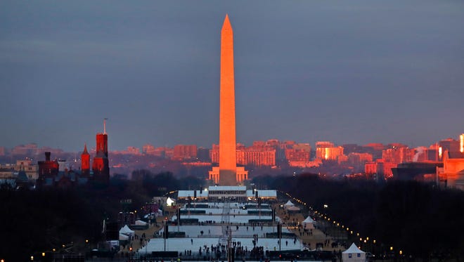 The crowd starts to fill the National Mall as the sun rises before the swearing in of Donald Trump as the 45th President of the United States during the Presidential Inauguration at the U.S. Capitol in Washington. Friday, Jan. 20, 2017.