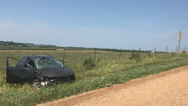 Sgt. Jerry Winter with the Minnehaha County Sheriff's Office and an unidentified state trooper survey a crash near La Mesa Drive and Maple Avenue northwest of Sioux Falls Monday afternoon.