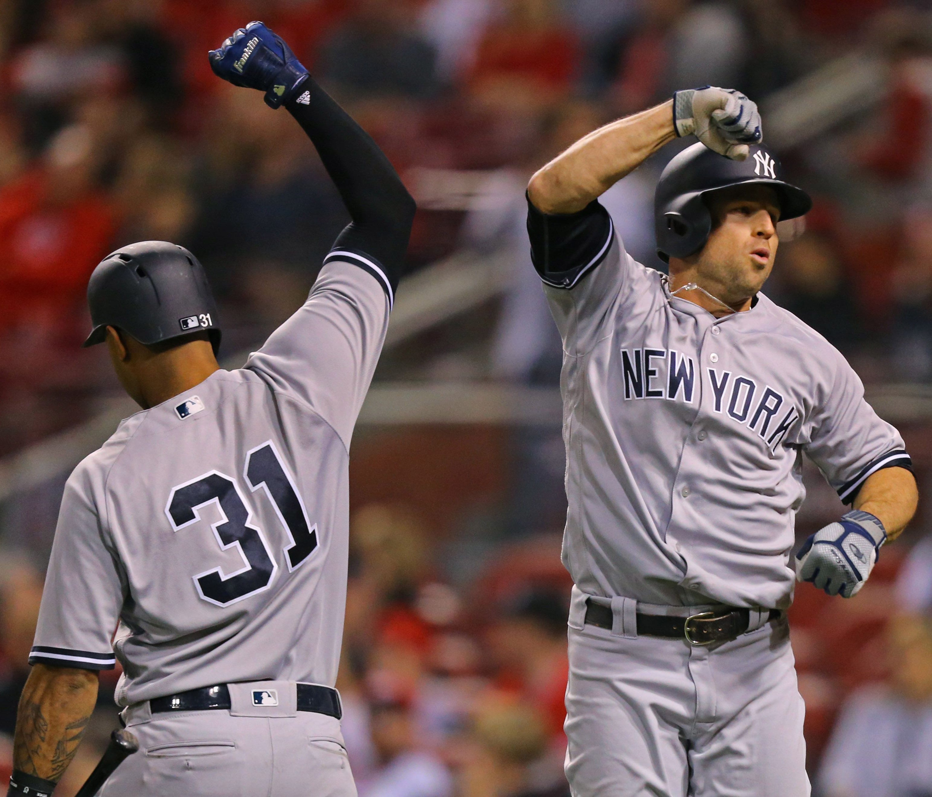 The Yankees' Brett Gardner, right, celebrates with teammate Aaron Hicks, left, after hitting a home run against the Reds in the eighth inning at Great American Ball Park in Cincinnati.