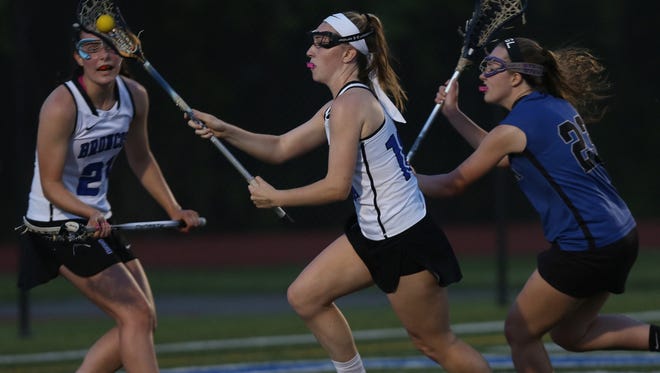 Bronxville's  Lilly Grass (10) drives to the goal in front of Pearl River's Bridget Duggan (23) during  the Section 1 Class C championship game at Mahopac High School May 26, 2016. 