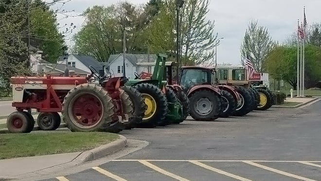 Friends of Braden Lemler organized a tractor parade to Colfax High School on May 14, in honor of Lemler who died in a rollover crash in Dunn County on May 11. Lemler loved tractors and the color red.