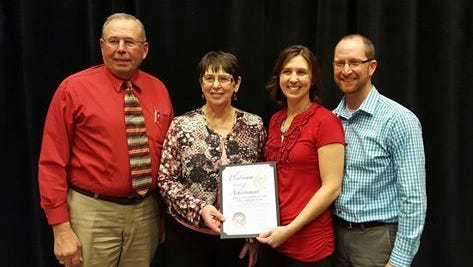 Vision-Aire Farms, owned by the Grade family, Eldorado, was recently honored as one of the top six farms in the nation for their milk quality. Accepting the award in Arizona are, from left, Roger and Sandy Grade, their daughter Janet (Grade) Clark and her husband, Travis Clark.