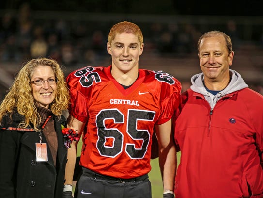 TimothyPiazza, center, with his parents Evelyn Piazza,
