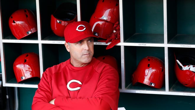 Reds manager Bryan Price waits to take in the lineup card before a game in May.