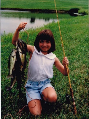 A happy Christina White with some bass and bluegill she caught from a farm pond.