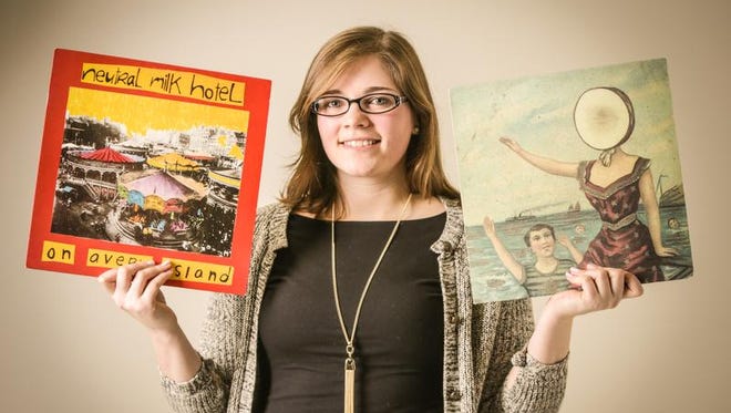 Neutral Milk Hotel fan Sami Norling holds the band’s studio albums: “On Avery Island,” left, and “In the Aeroplane Over the Sea.”