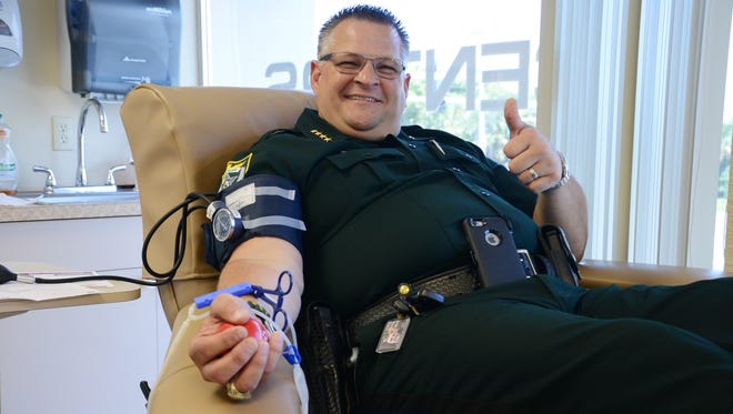 Brevard County Sheriff Wayne Ivey was one of dozens of people who waited in line at OneBlood in Titusville to donate blood in honor of BCSO Agent John "Casey" Smith, who was shot Thursday.