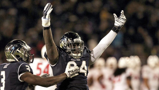 Nevada defensive end Lenny Jones celebrates after intercepting a pass in a 2014 win over Fresno State.Jones said he and his teammates are angry they have to play another Mountain west team, CSU, in the Dec. 29 Arizona Bowl.