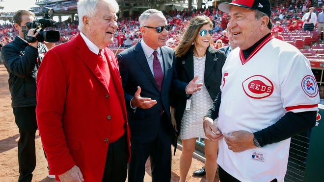 Cincinnati Reds owner Bob Castellini, left, MLB Commissioner Rob Manfred, center left, and former Reds catcher Johnny Bench, right, meet on the field before an opening day baseball game against the Pittsburgh Pirates, Thursday, March 28, 2019, in Cincinnati. (AP Photo/Gary Landers)