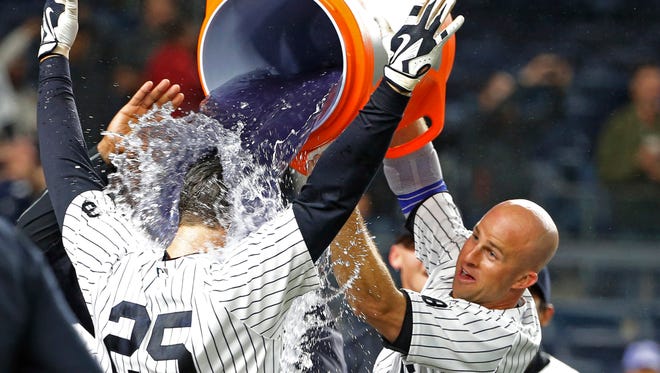 New York Yankees Brett Gardner, right, douses the Yankees' Mark Teixeira (25) with purple Gatorade after the Yankees defeated the Boston Red Sox 5-3 on Teixeira's ninth-inning, walk-off grand slam in a baseball game in New York, Wednesday, Sept. 28, 2016.