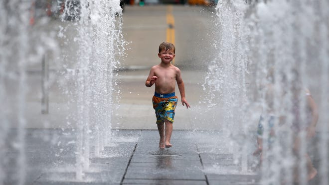 Lincoln Stutler, 4, of Burlington, Ky., runs through the fountains to stay cool, Thursday, July 20, 2017, at Smale Riverfront Park in Cincinnati. The National Weather Service expects temperatures in the mid to upper 90s Wednesday and Thursday and temperatures in the lower 100s Friday and Saturday.