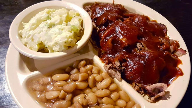 The barbecue brisket plate  ($9.75) topped with barbecue sauce with a side of beans and potato salad.
