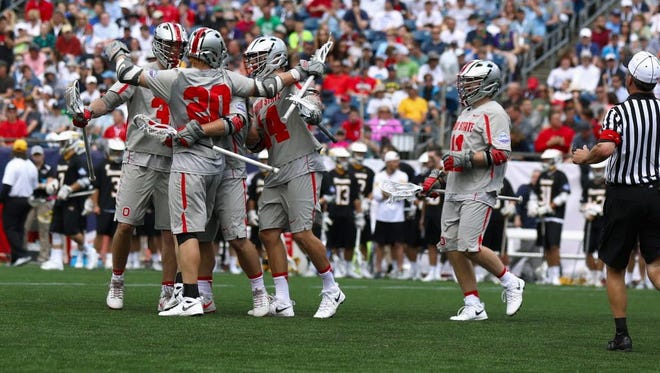 Ohio State's lacrosse team celebrates after scoring in the fourth quarter against Towson during the men's national semifinals at Gillette Stadium in Foxborough, Mass. on Saturday.