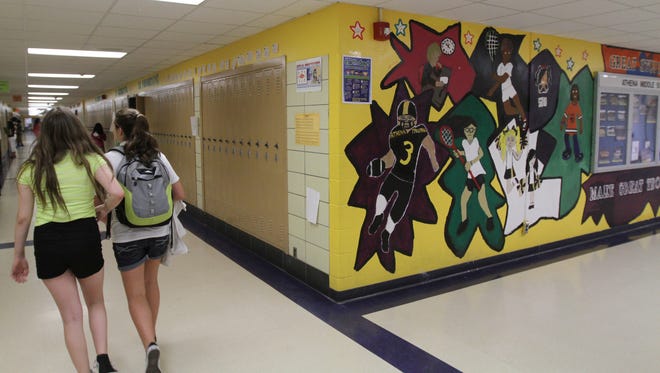 Students in sixth to eighth grade at Greece Athena Middle School painted a mural and mottoes on the walls throughout the school year. The 157 students were honored with a breakfast before school Wednesday.