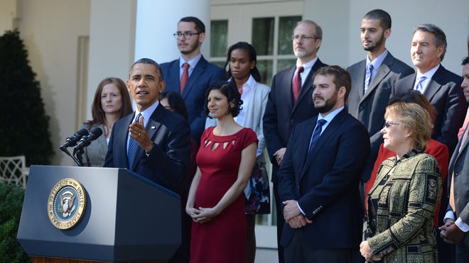 President Obama speaks about the Affordable Care Act alongside people who have already benefited from the legislation at the White House on Oct. 21.