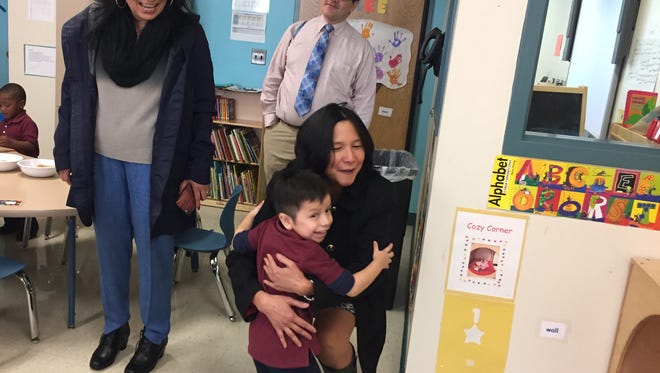 Dr. Velmina Rivera (right) gets a hug from 4-year-old Alan Hernandez at LEAP Academy University Charter in Camden. The school's founder, Gloria Bonilla-Santiago (left) recruited the pediatrician to care for the school's 2,000 students.