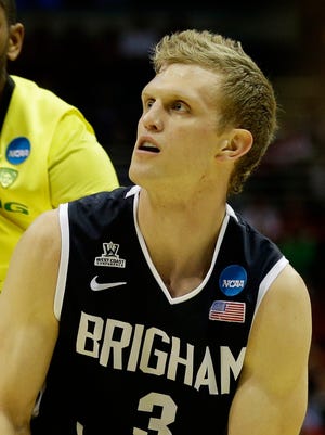 Brigham Young Cougars guard Tyler Haws (3) lines up a shot, guarded by Oregon Ducks forward Mike Moser (0) during the second round of the 2014 NCAA Tournament at BMO Harris Bradley Center.