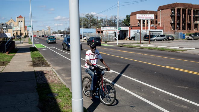 Willie McCaplin uses a bike lane along North Cleveland Street in March, 2016.