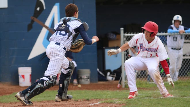 Zane Trace's Joel Dunkle tries to elude a tag from Adena's Russell in the top of the fourth inning. Dunkle was called out but the Pioneers got the last laugh with a 7-6 win in Frankfort.