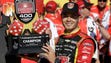 Kyle Larson holds the FireKeepers Casino 400 trophy