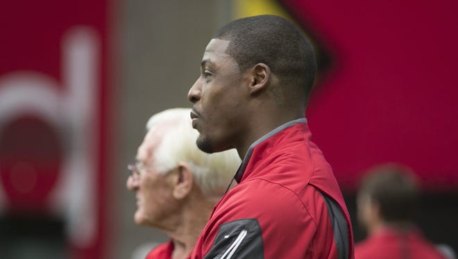 Former Arizona Cardinals safety Adrian Wilson watches practice at University of Phoenix Stadium in Glendale on Friday, August 7, 2015.
