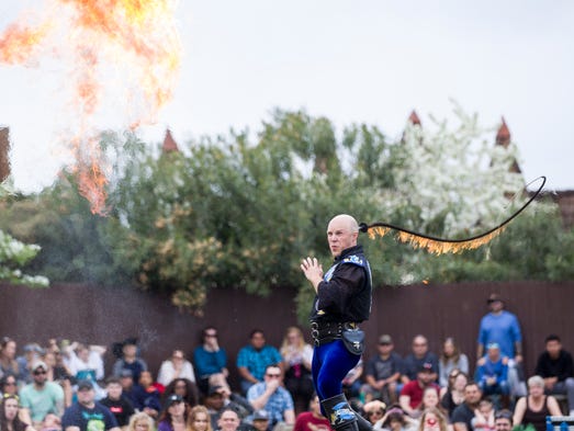 Adam Crack performs a fire-whip show during the Arizona
