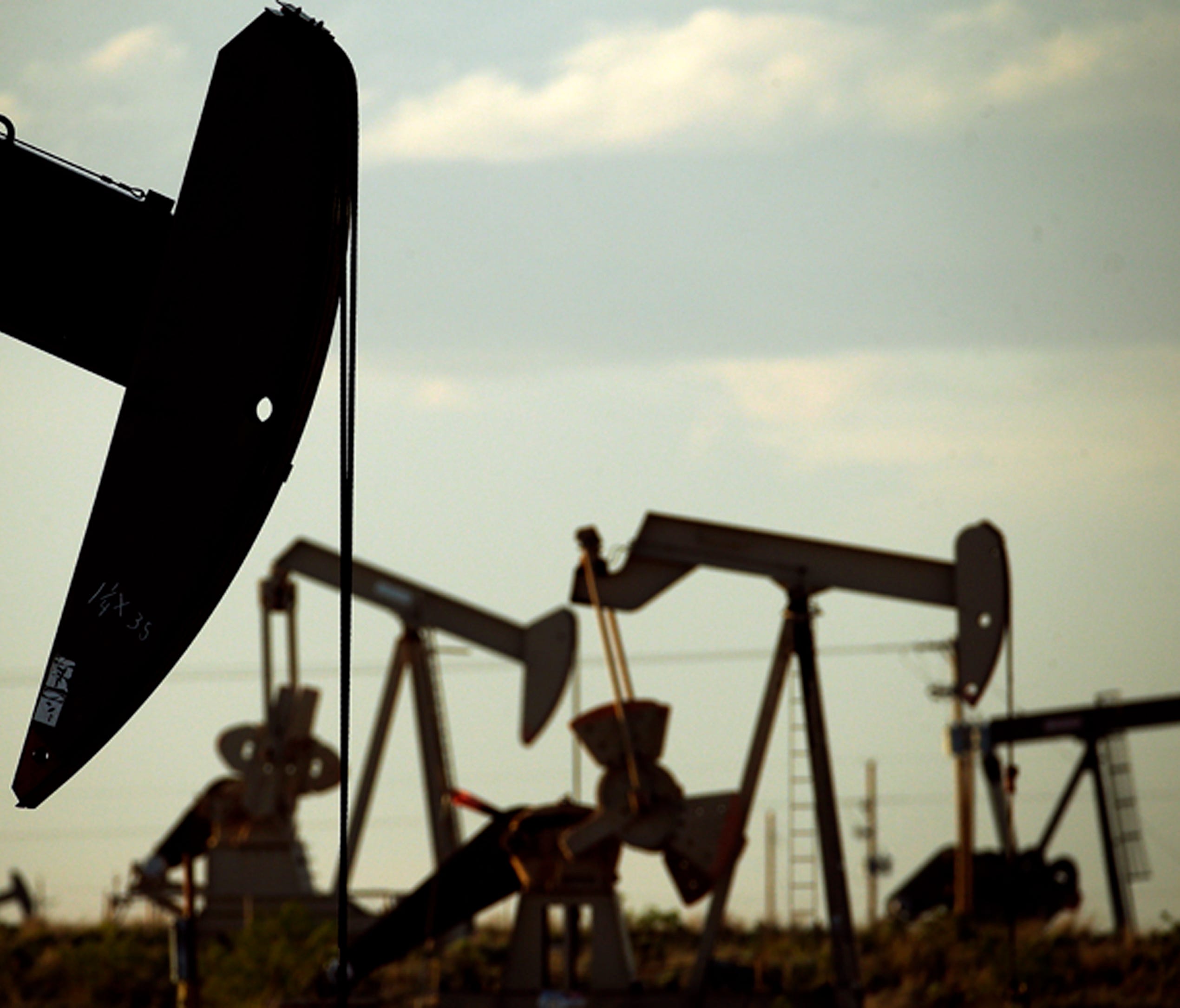 File photo taken in 2015 shows oil pumpjacks working in a field near Lovington, New Mexico.