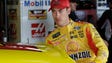 Joey Logano enters his car before a practice session,