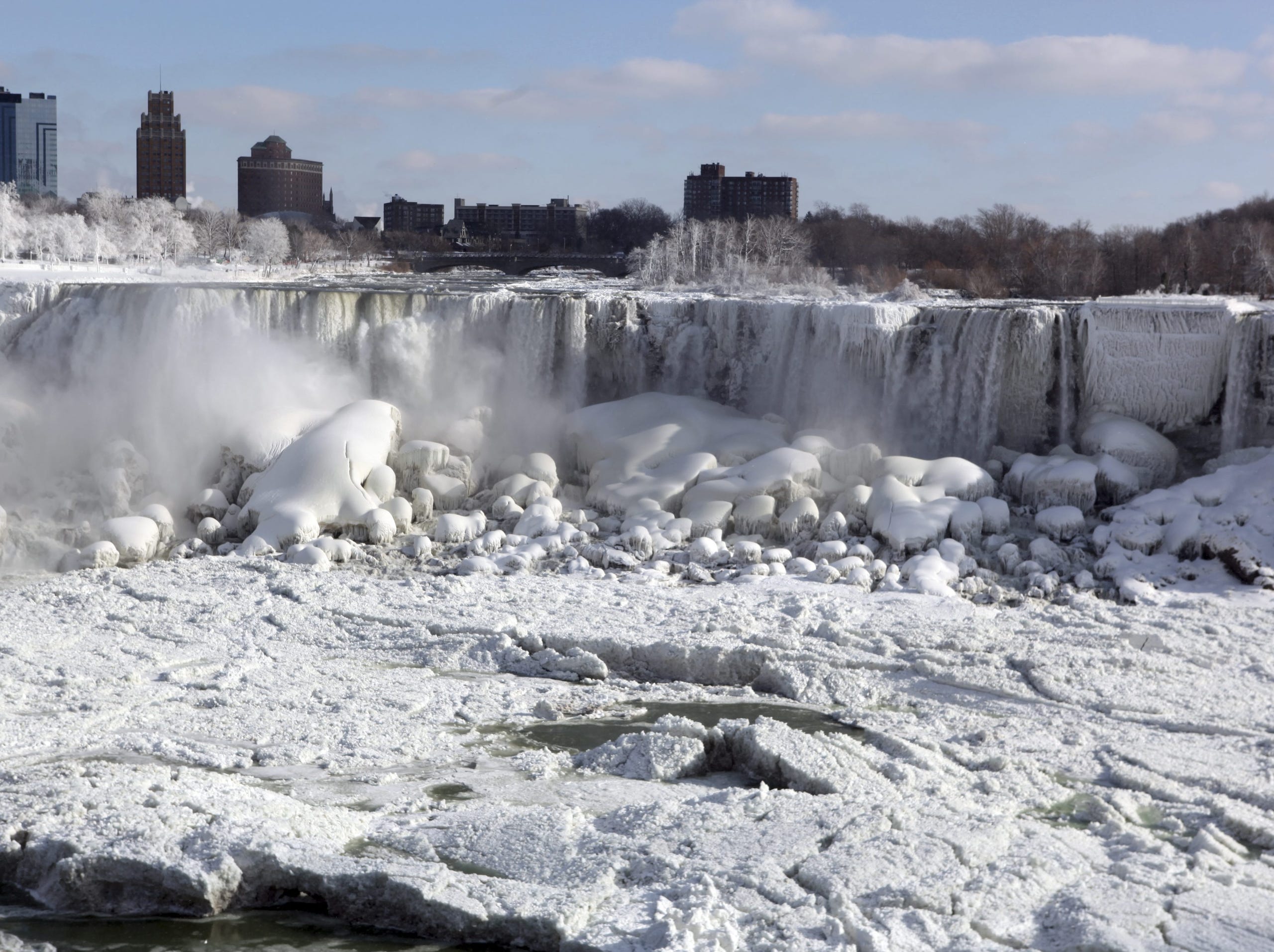 The Canadian and U.S. sides of Niagara Falls are covered in ice Thursday.