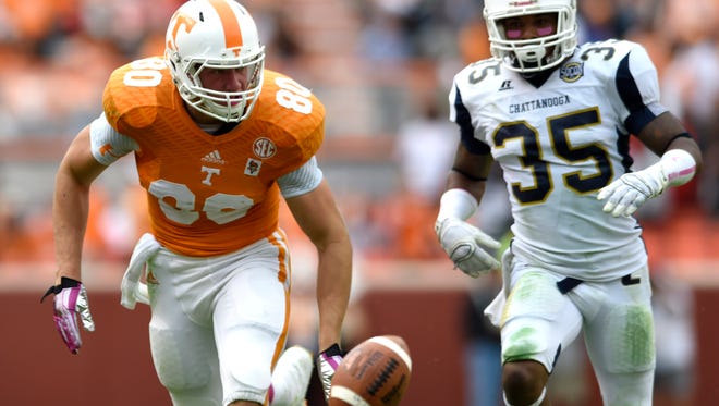 A long pass from Tennessee quarterback Justin Worley (14) falls beyond the reach of Tennessee tight end Daniel Helm (80) as Chattanooga defensive back Cedric Nettles (35) gives chase during the first half at Neyland Stadium, Saturday, Oct.11, 2014 in Knoxville, Tenn. (ADAM LAU/NEWS SENTINEL)