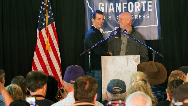 FILE-  In this May 11, 2017 file photo, Republican Greg Gianforte, right, welcomes Donald Trump Jr., the president's son, onto the stage at a rally in East Helena, Mont. Gianforte, a businessman, kept Trump at arm’s length when he unsuccessfully ran for Montana governor on the GOP ticket last year. Now he’s wholeheartedly embracing his party’s president in his race for the state’s open congressional seat. (AP Photo/Bobby Caina Calvan, File)