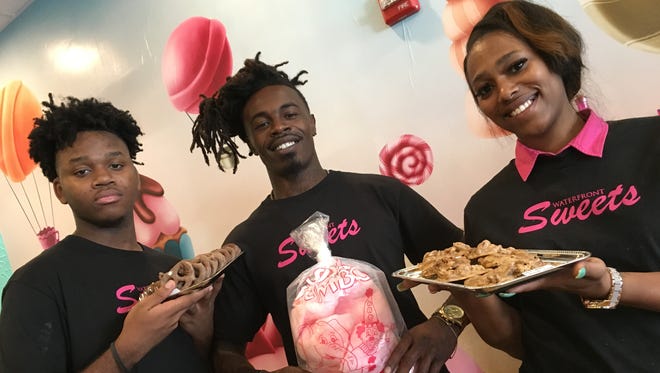 From left, Kron Morris, Mykell Wheeler and Taneka Reid show off some of the goodies at the new Waterfront Sweets on Dexter Avenue.