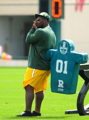 Green Bay Packers injured defensive tackle B.J. Raji watches training camp practice at Ray Nitschke Field, Monday, August 25, 2014. H