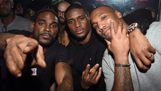 From left, DJ Stevie J, Detroit Lions running back Reggie Bush and Indianapolis Colts linebacker Shaun Phillips attend a party Sunday, Feb. 1, 2015, in Scottsdale, Arizona.