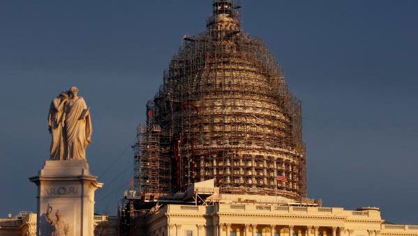 The U.S. Capitol dome is seen under repair on Capitol Hill, Sunday, Nov. 22, 2015 in Washington. (AP Photo/Alex Brandon) ORG XMIT: DCAB103