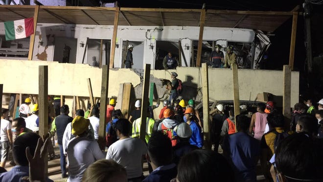 Rescue teams work at the Rébsamen school in Mexico City early morning on Sept. 20, 2017.
