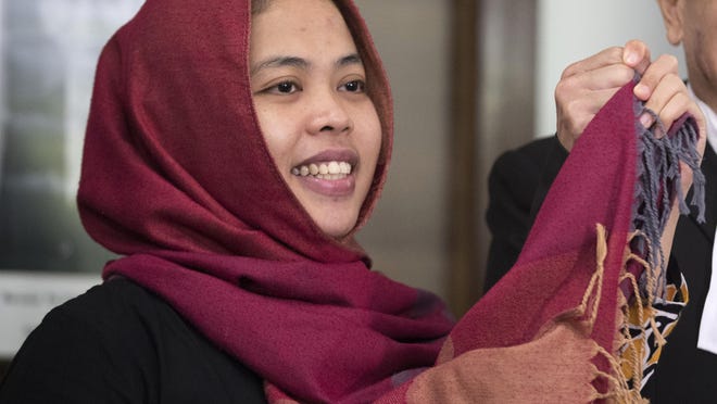 Indonesian Siti Aisyah, left, smiles next to her lawyer Gooi Soon Seng after a press conference at Indonesian Embassy in Kuala Lumpur, Malaysia, March 11, 2019. The Indonesian woman held two years on suspicion of killing North Korean leader's half brother Kim Jong Nam was freed from custody Monday after prosecutors unexpectedly dropped the murder charge against her.
