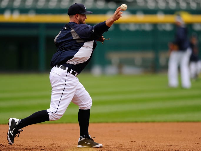 Tigers' catcher Bryan Holaday participates in infielder drills during Saturday's practice.