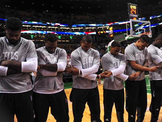 Members of the Boston Celtics pay tribute to the national