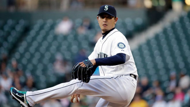Seattle Mariners starting pitcher Hisashi Iwakuma throws against the Houston Astros in a baseball game Monday, April 20, 2015, in Seattle.