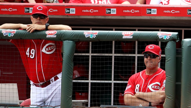 Reds bench coach Jay Bell, left, and manager Bryan Price watch as their team falls in Wednesday's series finale.
