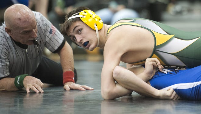 Clearview's Brandon Dick, top, wrestles in a 145-pound bout in the Arthur O. Marinelli tournament at Egg Harbor Township on Dec. 29. The Pioneers are coached by Stephen Duncan, who took the job after Keith Mourlam decided against coaching to deal with personal issues.