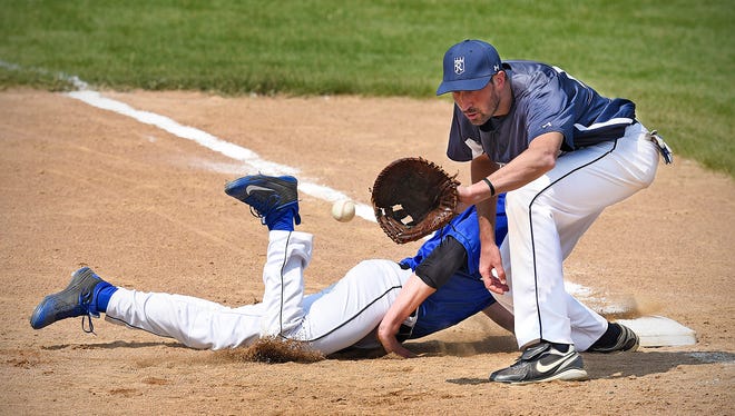 Lake Henry's Matt Quade safely dives back into first base before the tag by Richmond's Cory Niewind  during the sixth inning Sunday, May 8, in Richmond.