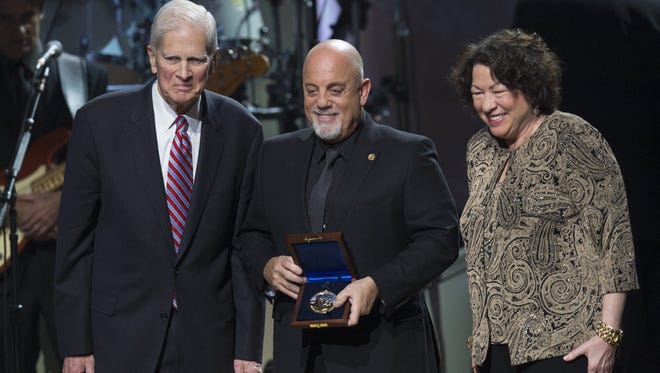 Billy Joel, center, recipient of the 2014 Library of Congress Gershwin Prize for Popular Song, stands alongside Supreme Court Justice Sonia Sotomayor and Librarian of Congress James Billington during a tribute concert in his honor at DAR Constitution Hall in Washington, D.C., on Nov. 19, 2014.