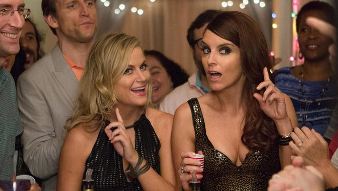 Amy Poehler (left) and Tina Fey star in “Sisters.”