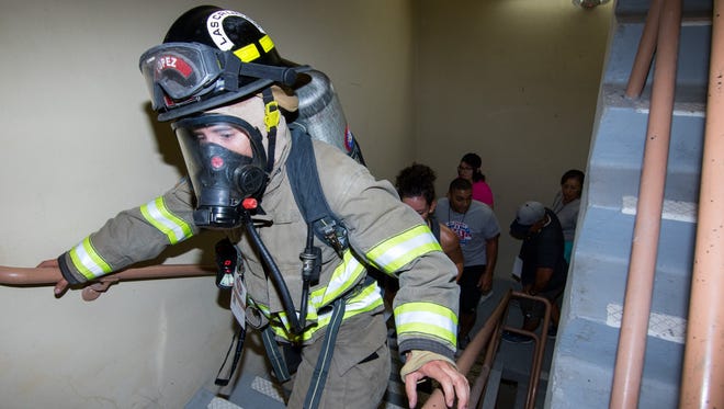 Las Cruces Firefighter Matthew Lopez leads participants in Las Cruces Memorial Stair Climb event on Sunday, Sept. 10, 2017. The fundraising event, held as a memorial to 9/11, took place at the Wells Fargo Tower.