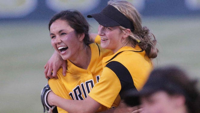 Avon High School's #28, Maddison Brock, left, is congratulated by team mate Haylie Foster, right, after making the game winning catch, during the High School Softball Regionals against the Decatur Central, Tuesday May 31st, 2016. The Avon Orioles beat the Decatur Hawks during the High School Softball Regionals, at Decatur Central.