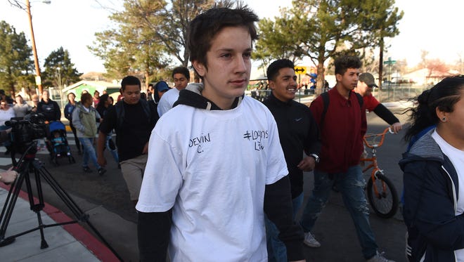 Over 100 people, including Devin Clark, marched from Pat Baker Park to the Washoe County School District Administration Building to present a petition asking to allow school police to be able to carry pepper spray and Tasers in Reno on Dec. 14, 2016.  The march and petition were in response to the shooting of 14-year-old Logan Clark by a WCSD police officer at Hug High School last week.